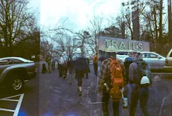 a group of people walking on a sidewalk