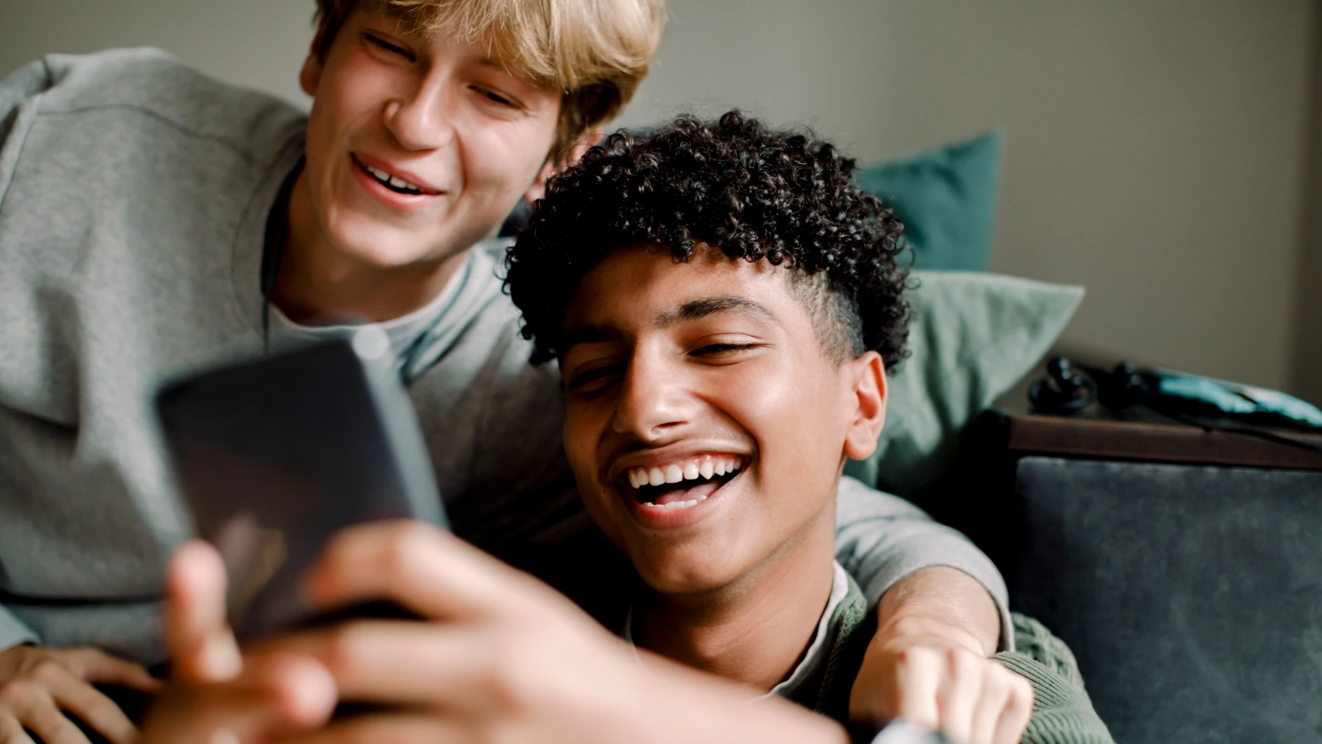 boy using mobile with friend - Is It Normal to Masturbate at 13