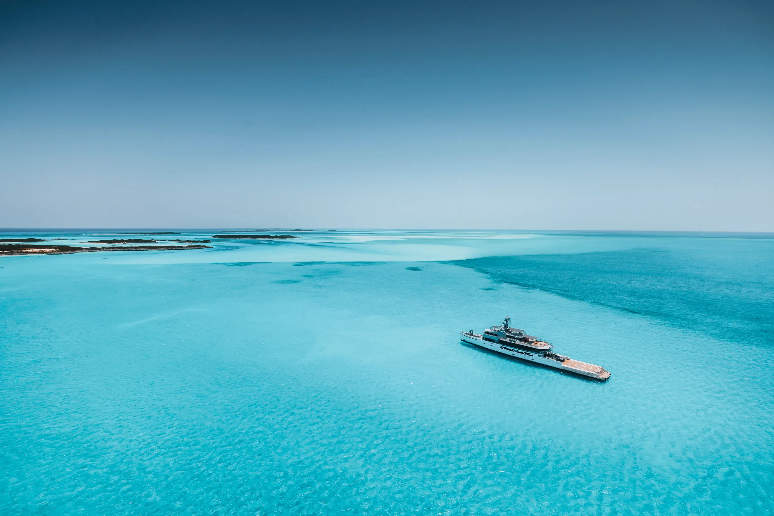 Cozy orange velvet lounge chair by glowing lamp.