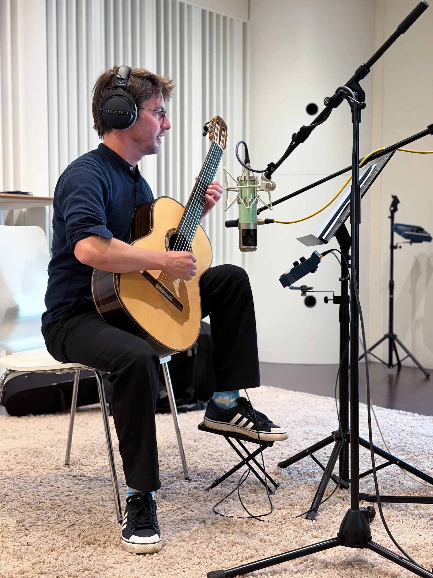 brandy jingles recording a guitar with microphones