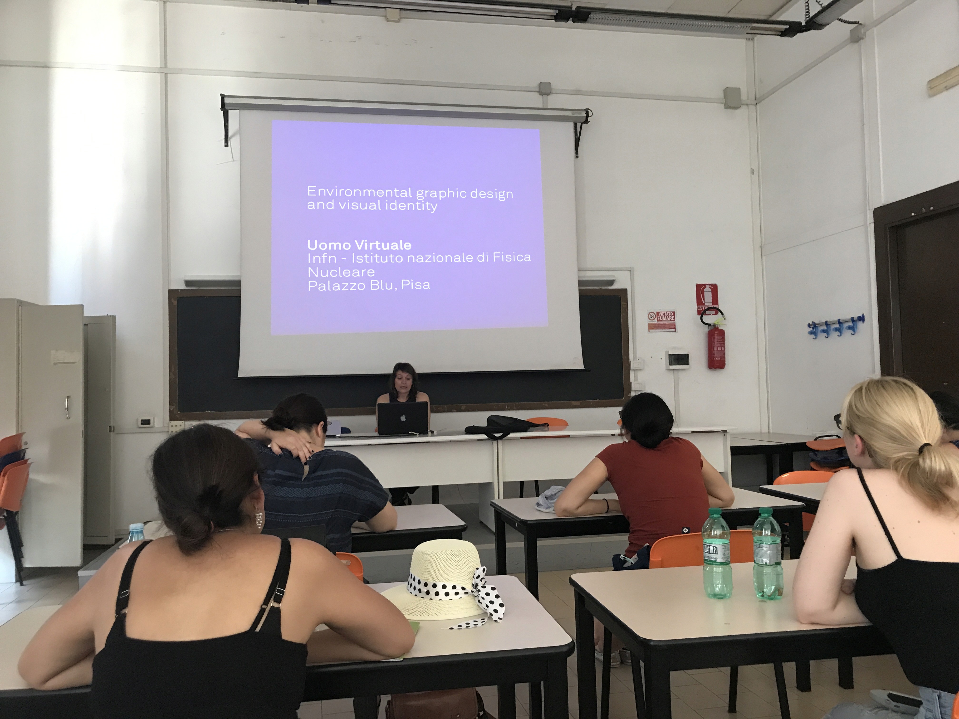 Students following a lecture on a projector screen.