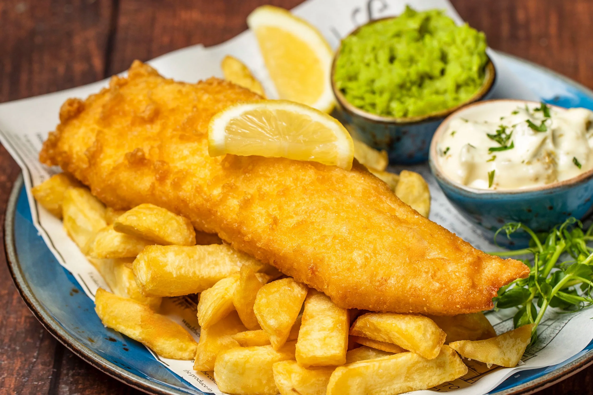 Crispy battered cod served with perfectly golden chips, mushy peas and tangy tartar.