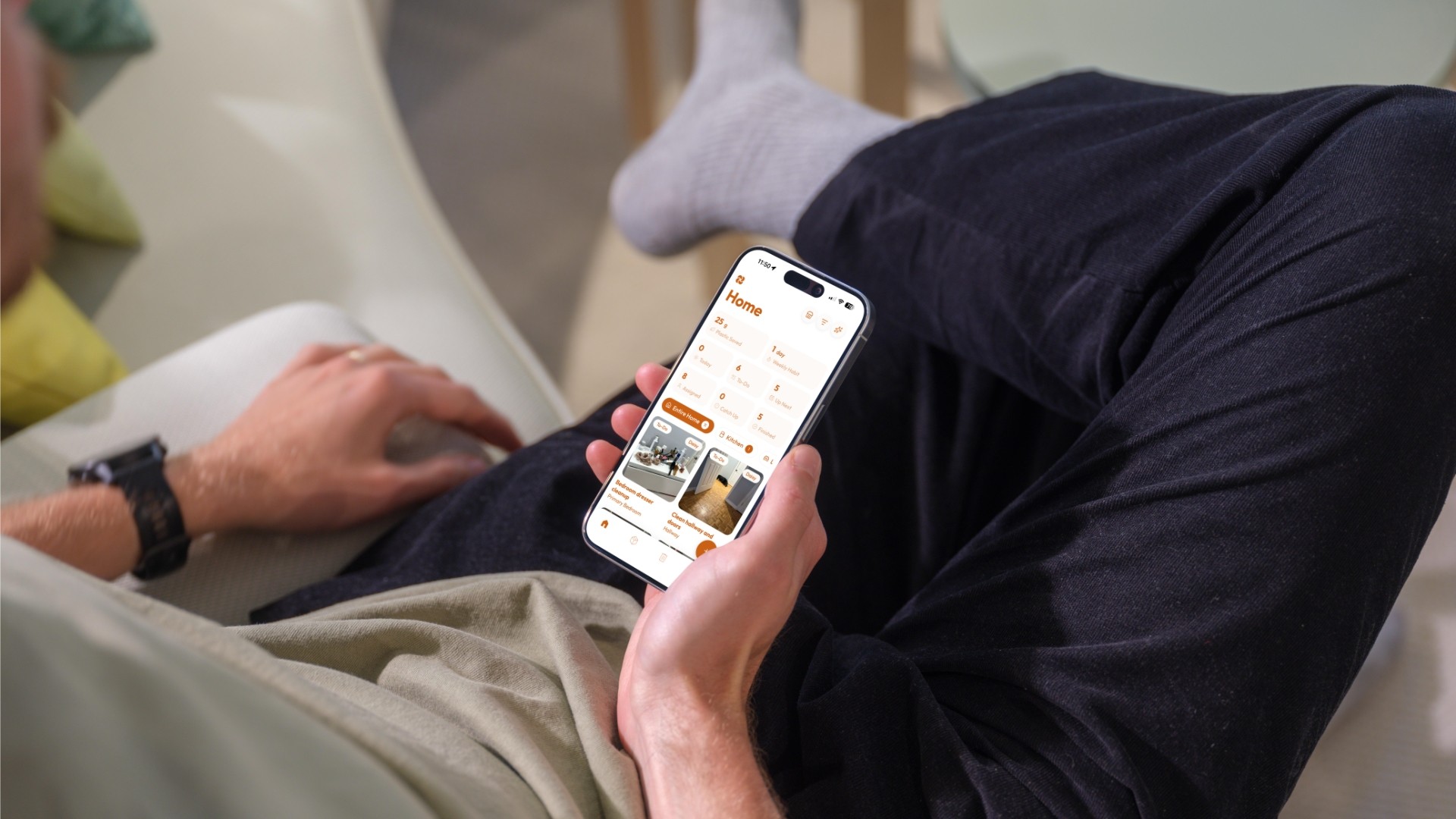 Someone using a photo-first household chore app on their phone in a tidy home, a dedicated, sustainable alternative to Cozi.