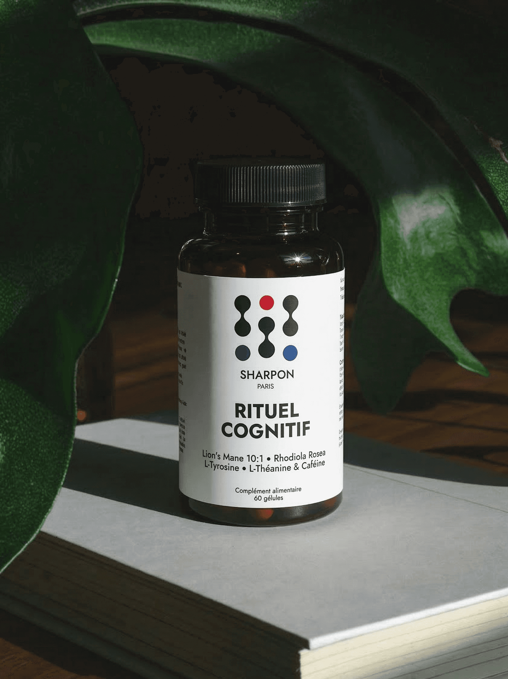 Bottle of Sharpon rituel cognitif (nootropic) on a surface with green leaves in the background
