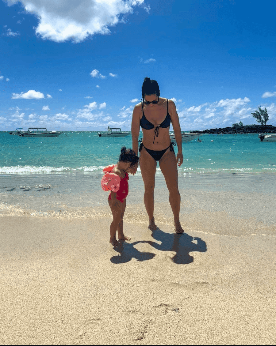Maman avec son enfant à la plage sous le soleil pour illustrer les précautions à prendre quand il fait chaud