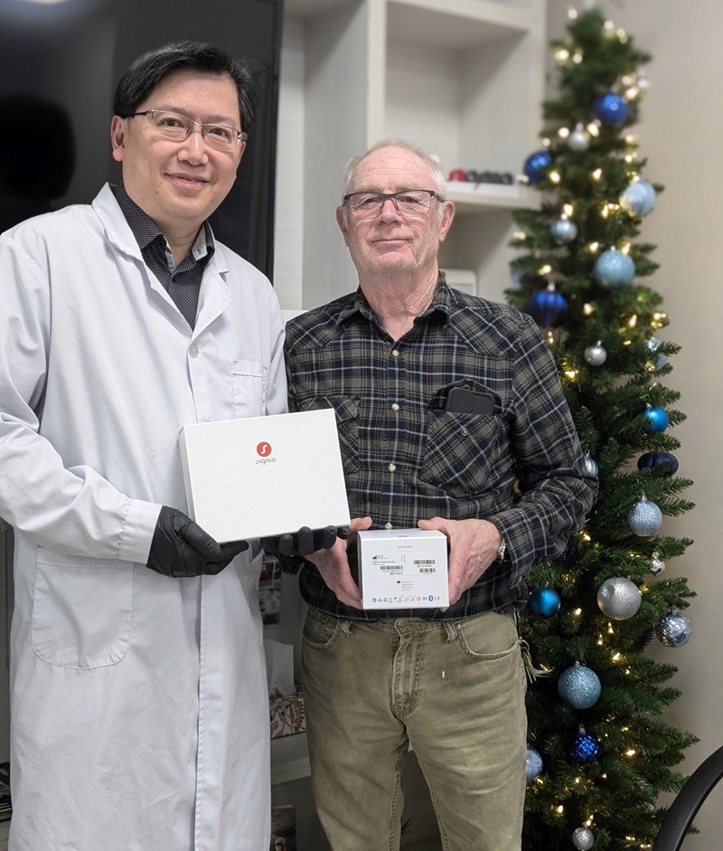 woman lying on white flooring holding grapes beside apple fruits