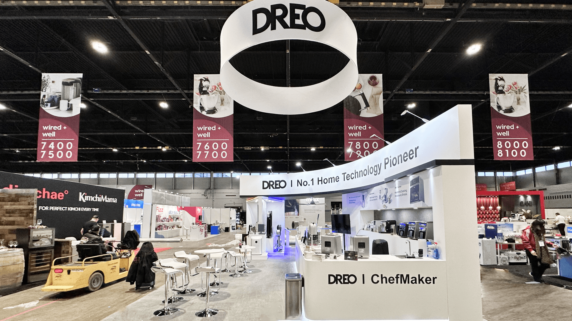 Chicago 30x30 trade show booth build at McCormick Place featuring overhead hanging sign, open seating area, and product demonstration counters