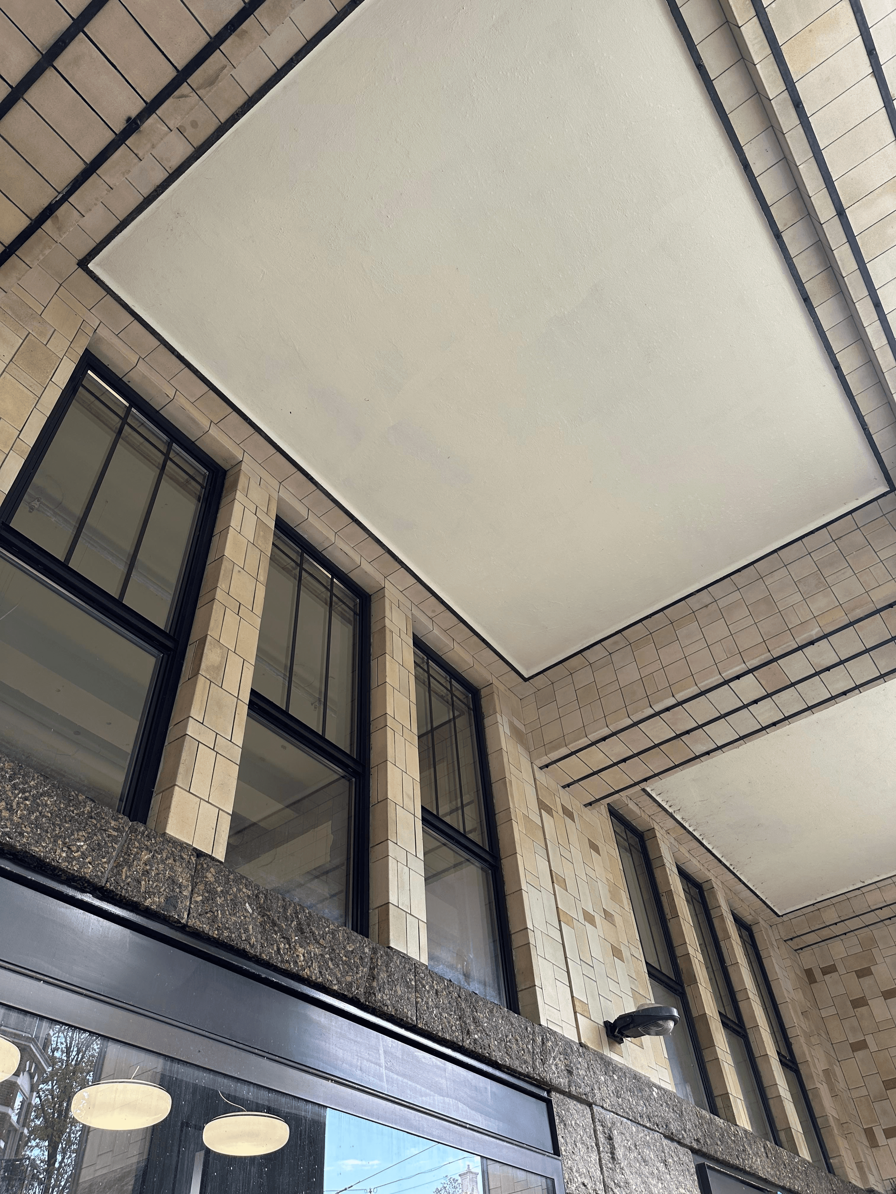 A diverse team collaborates around a table, analyzing documents and charts in a professional setting with a light green background.