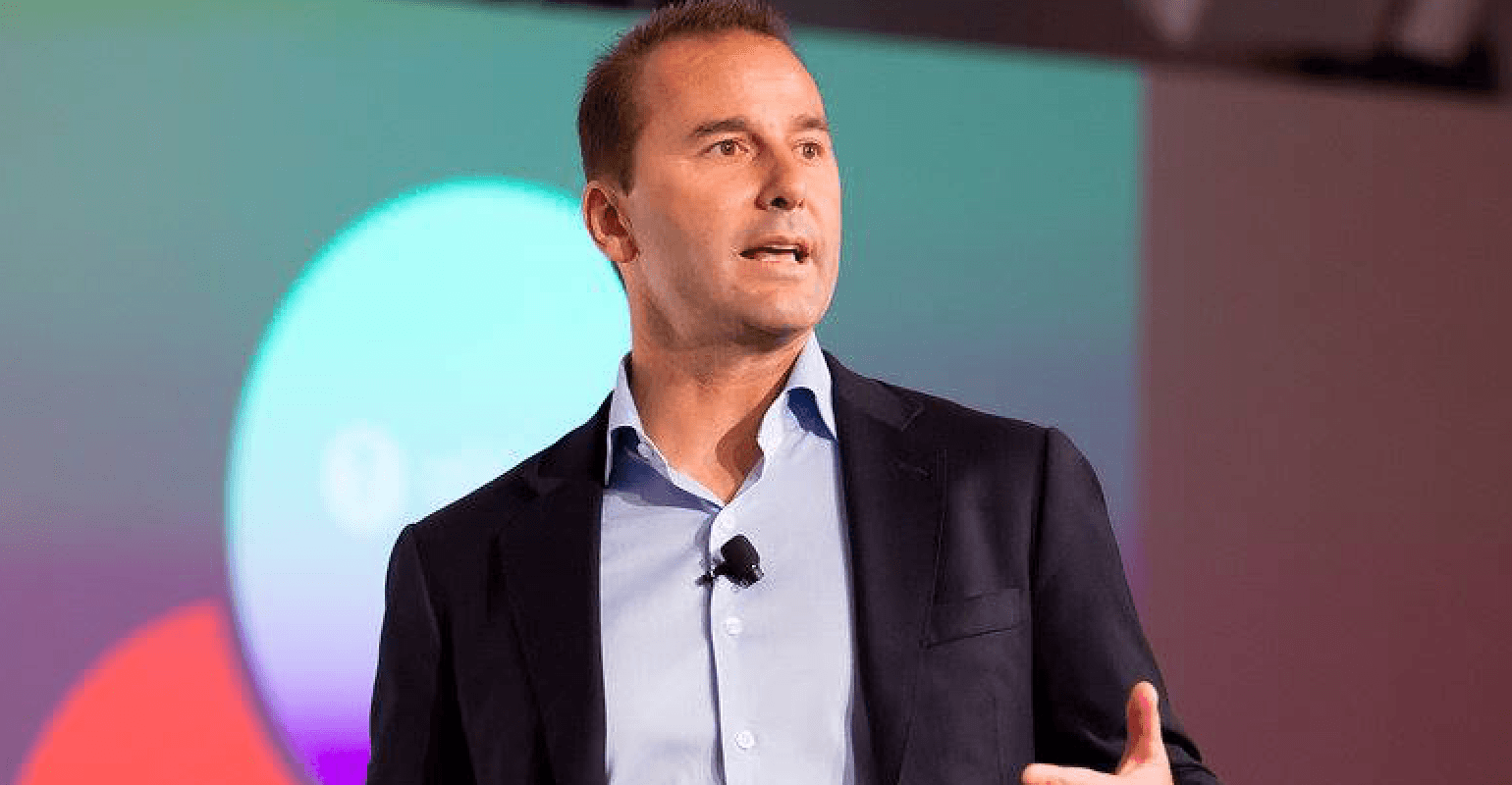 Black and white portrait of a smiling person with curly hair