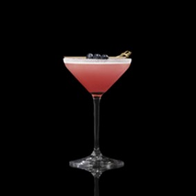 A closeup of a Blueberry Lemon Drop drink against a dark background.