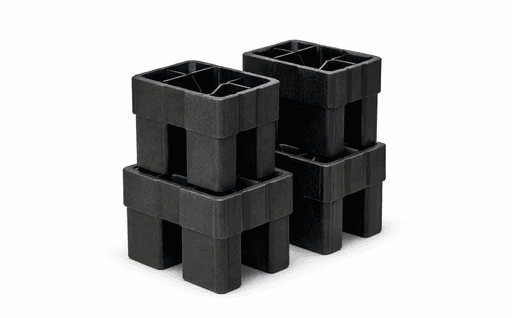 Black plastic pallet blocks used as traditional dunnage supports for heavy load stabilisation in transport and storage applications.