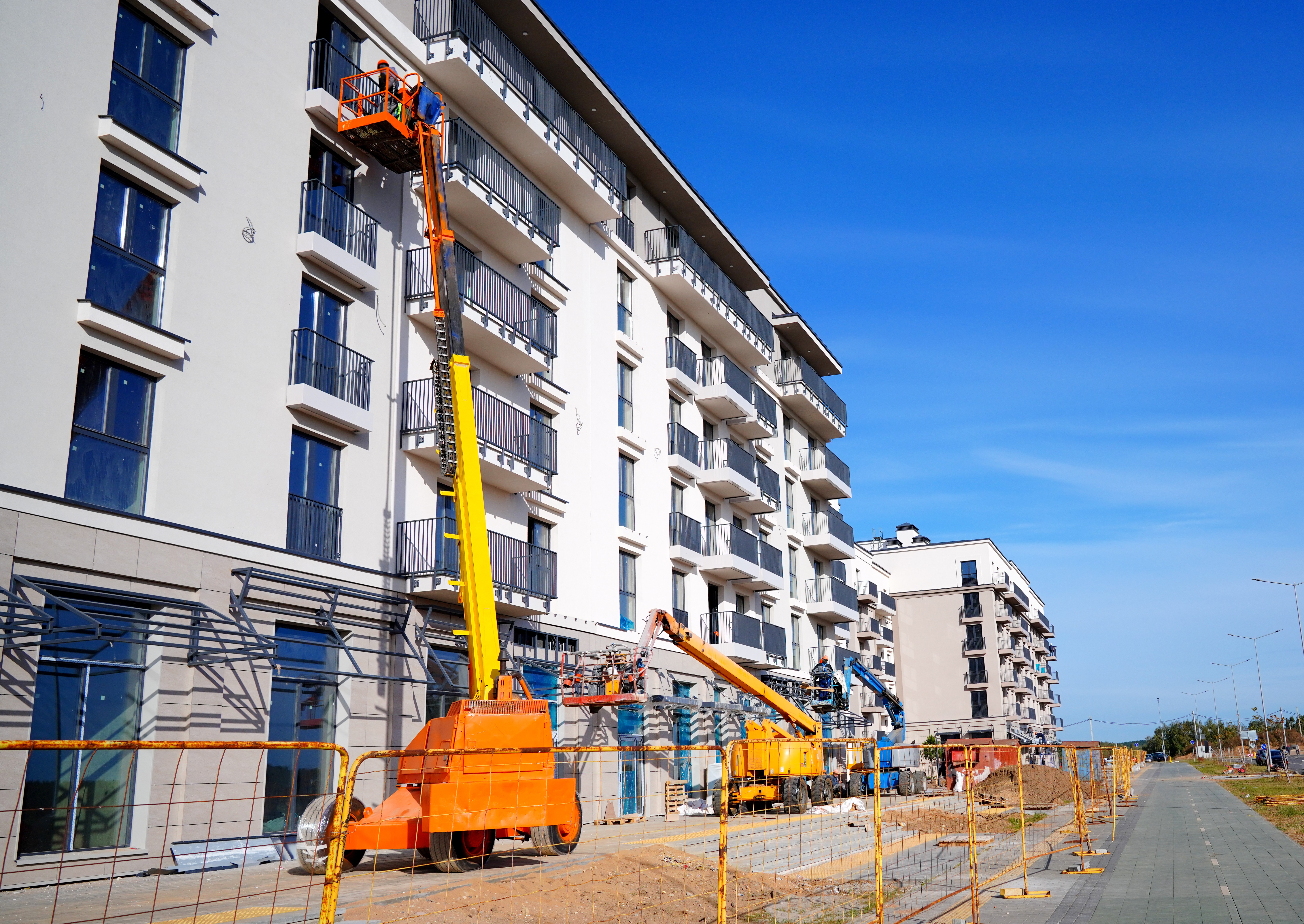 Commercial apartment building repaint in progress with cherry picker — Gold Coast commercial painters
