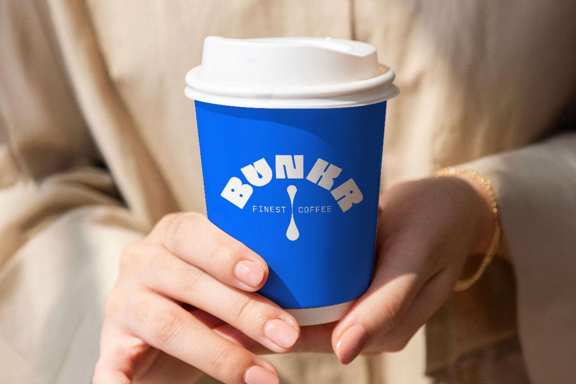 Three bottles of Somni Evening Seltzer sitting on a table at a rooftop party