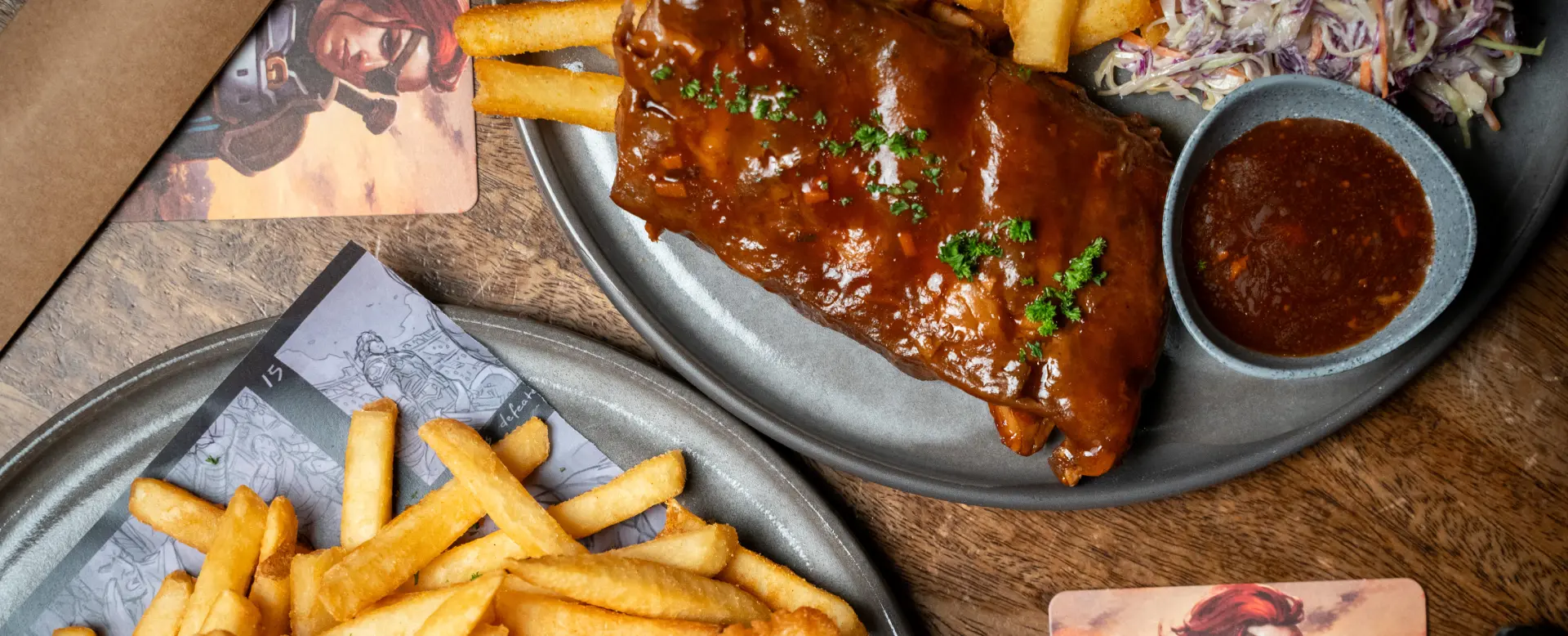 A cropped and close up picture of fries and pork ribs