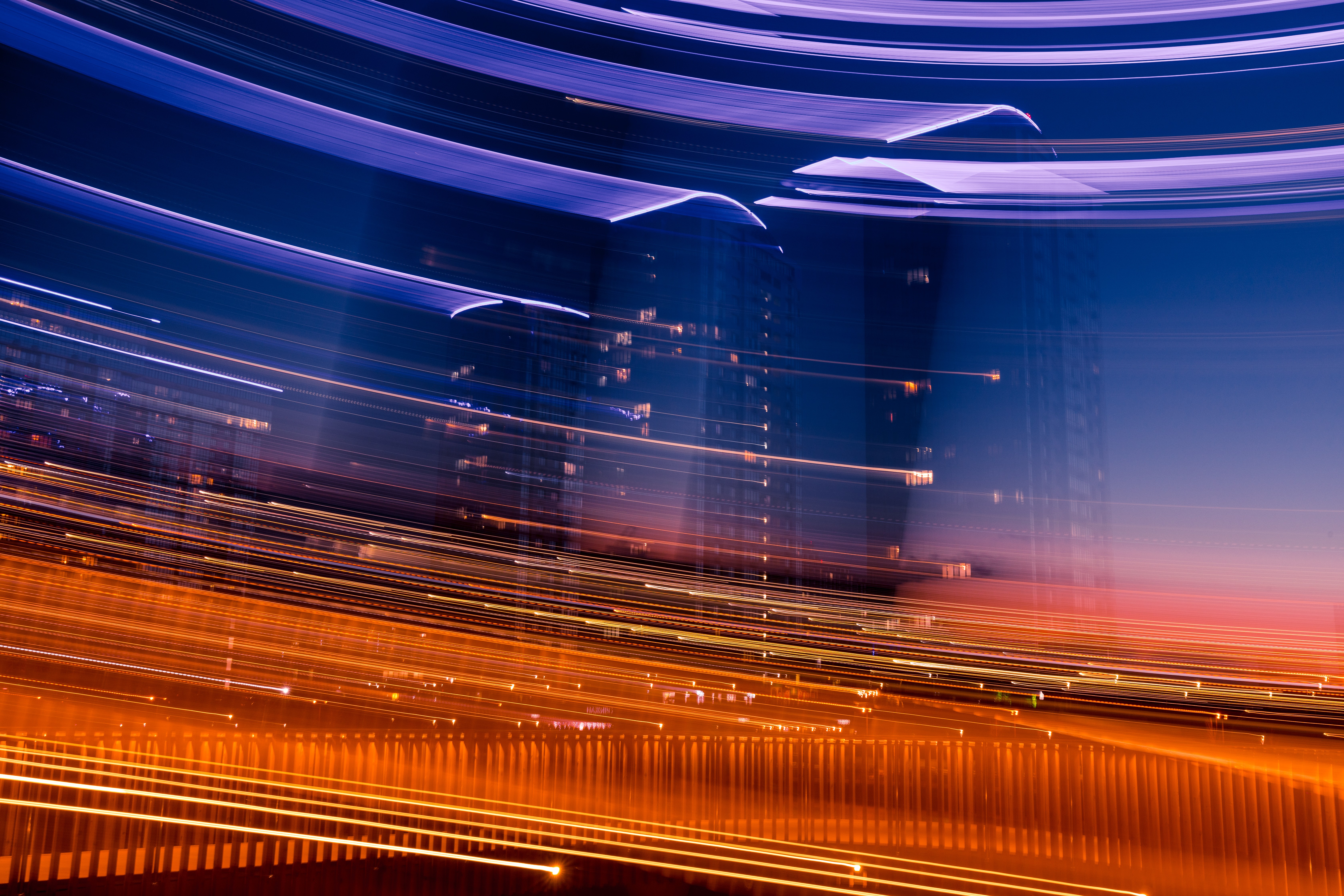 Nighttime city lights with purple and orange streaks
