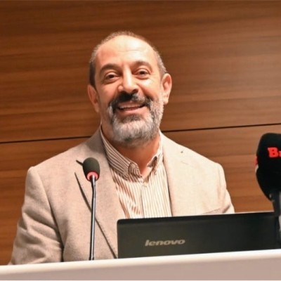 woman in black crew neck t-shirt wearing brown framed eyeglasses standing on rocky shore during