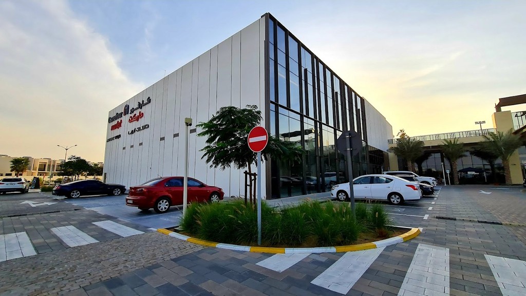 Carrefour store located in DAMAC Hills 2, near the Santorini area, featuring a modern exterior and accessible entrance.