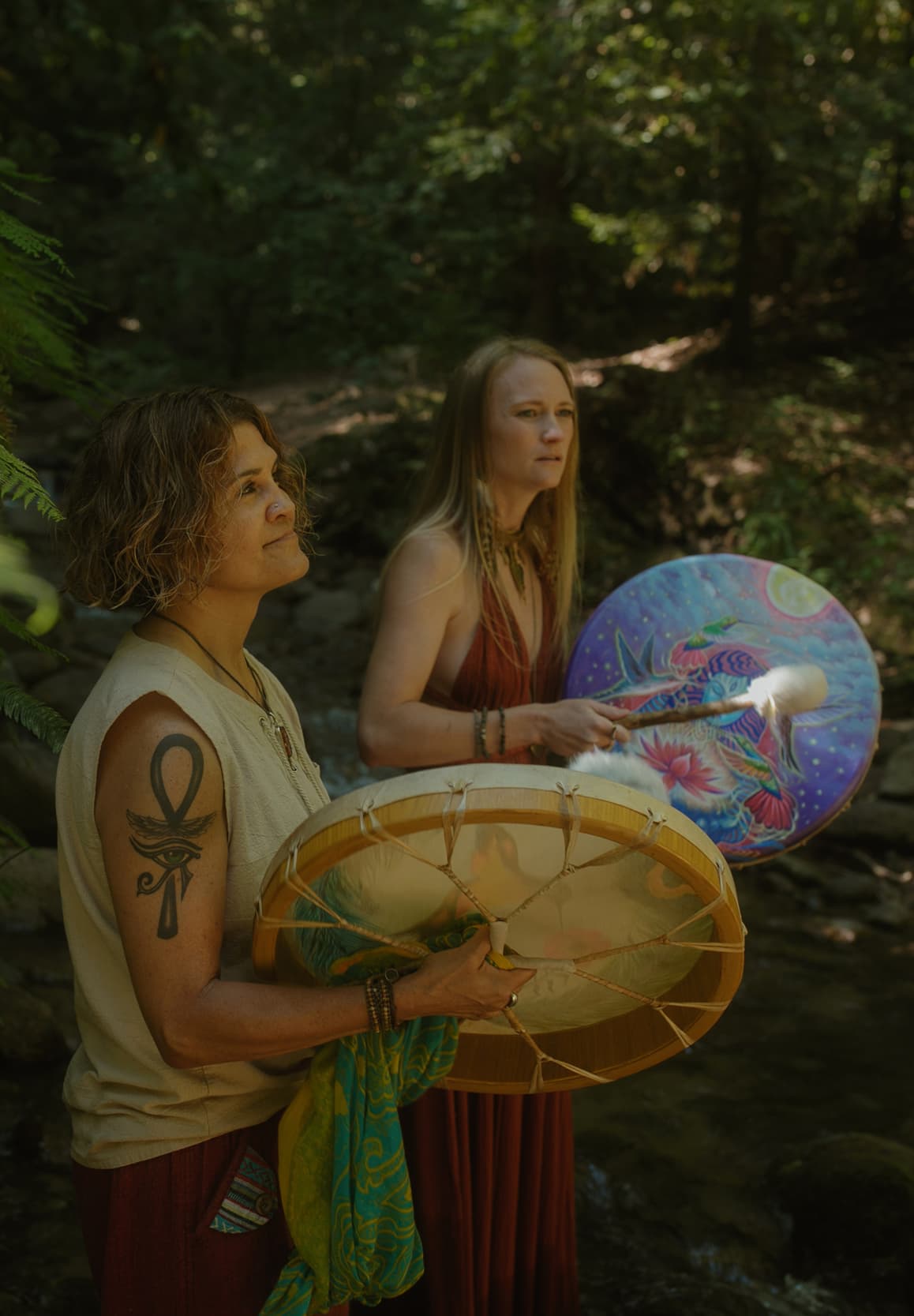 Emeline and Sonia holding sacred ceremonial drums during plant medicine ceremony