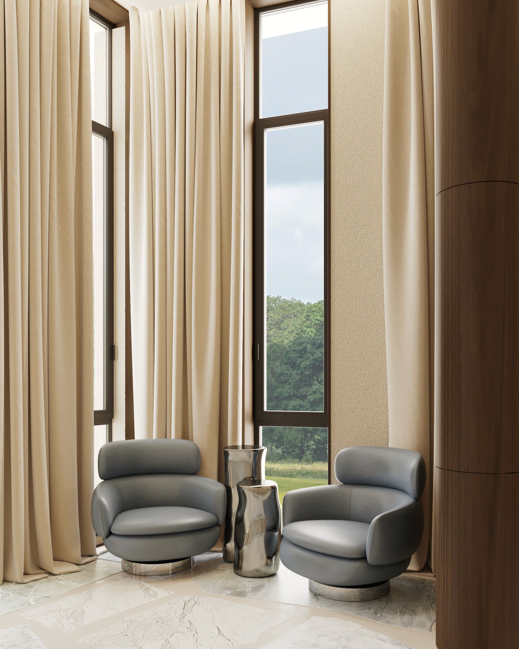 Two gray armchairs facing each other with tall windows and cream curtains.
