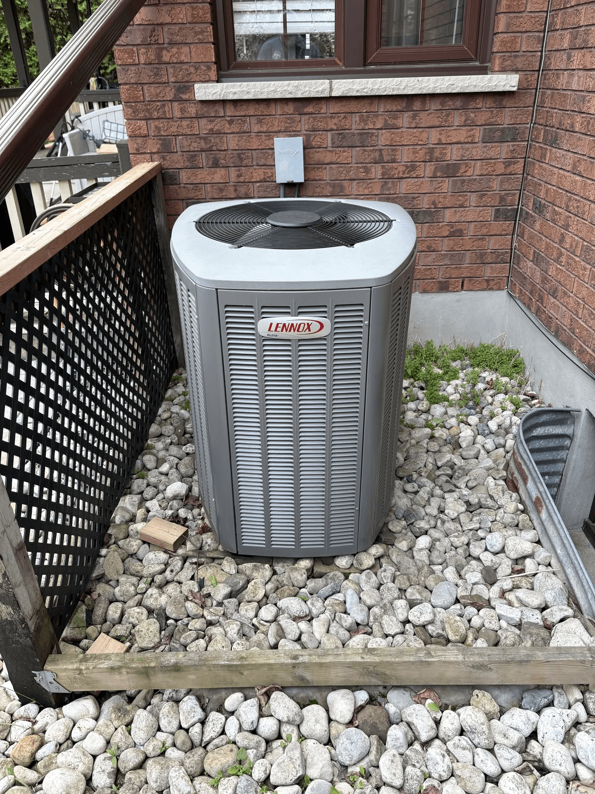 Lennox central AC, side-of-house install. 10-year parts and labour warranty registered before we left.