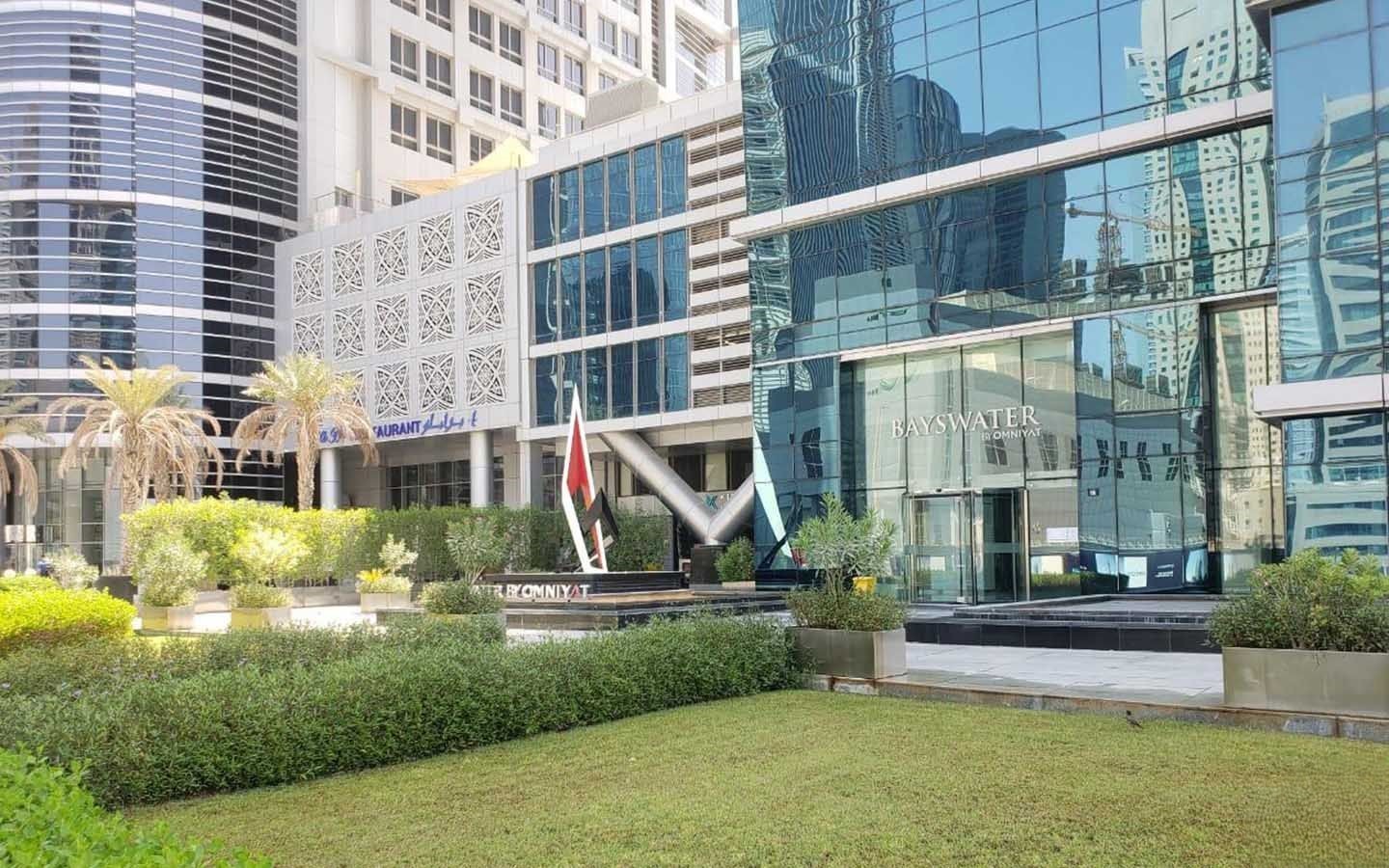 Beautifully landscaped exterior of a modern office building, curated by expert real estate agents.