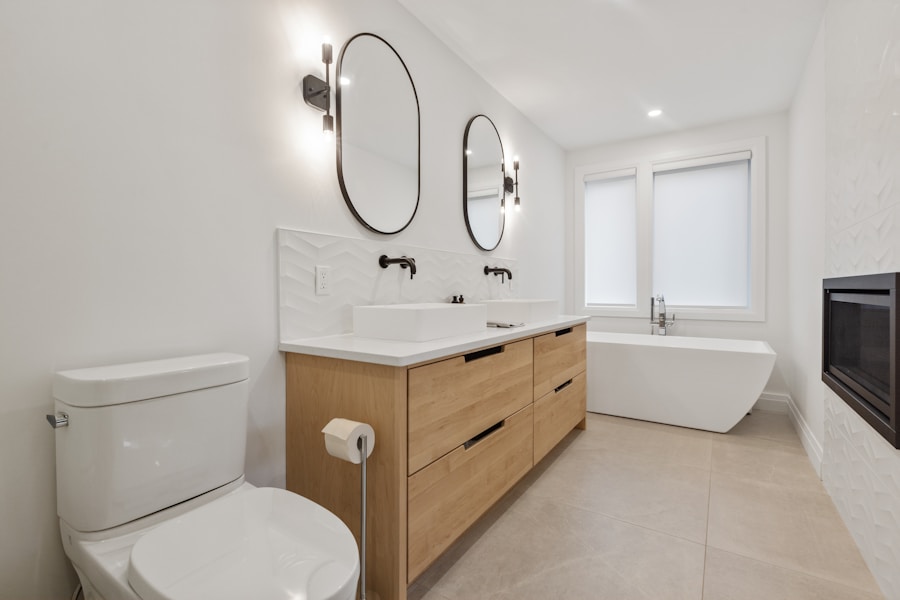 Bathroom renovation by Zenbuild, Hawke's Bay — timber double vanity with oval mirrors and freestanding bath