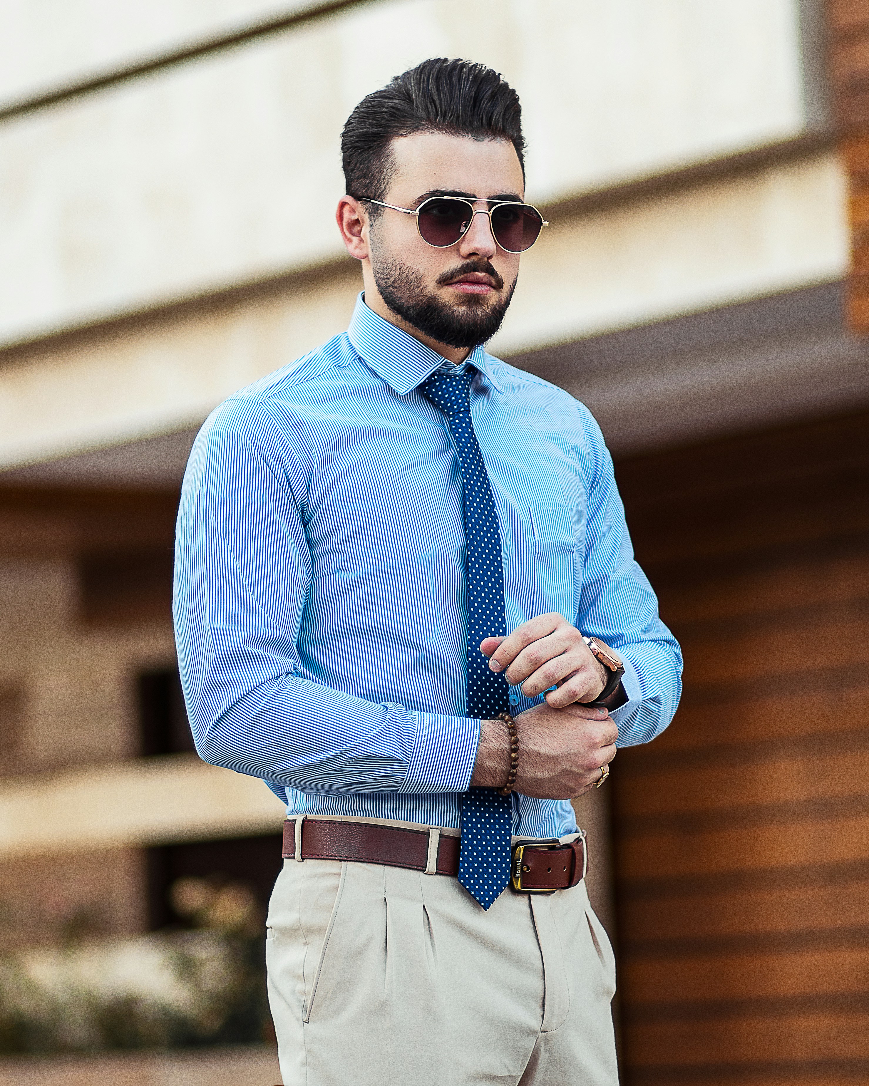 man in blue dress shirt wearing black sunglasses