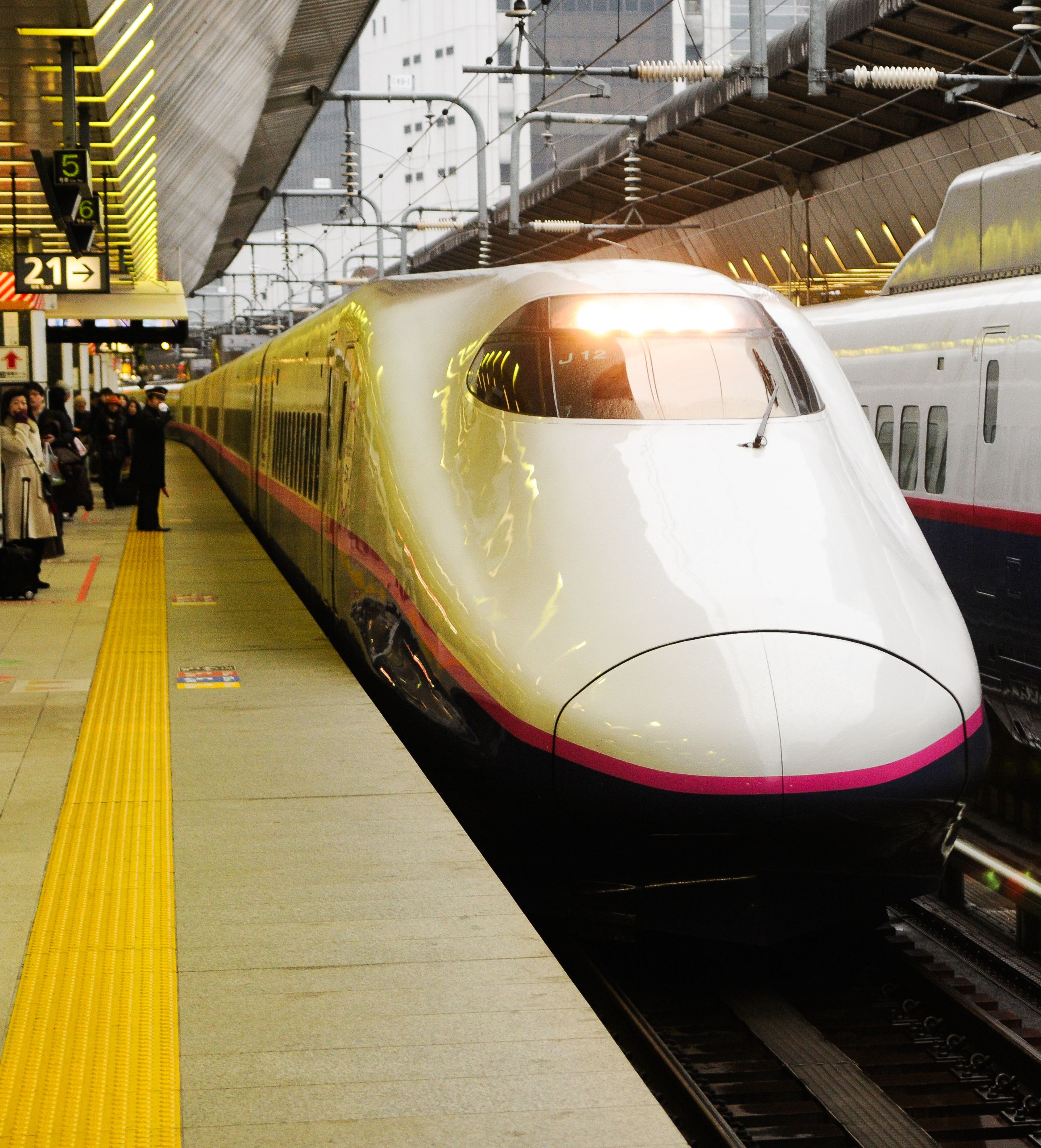 Shinkasen with white pink and black color idel at station