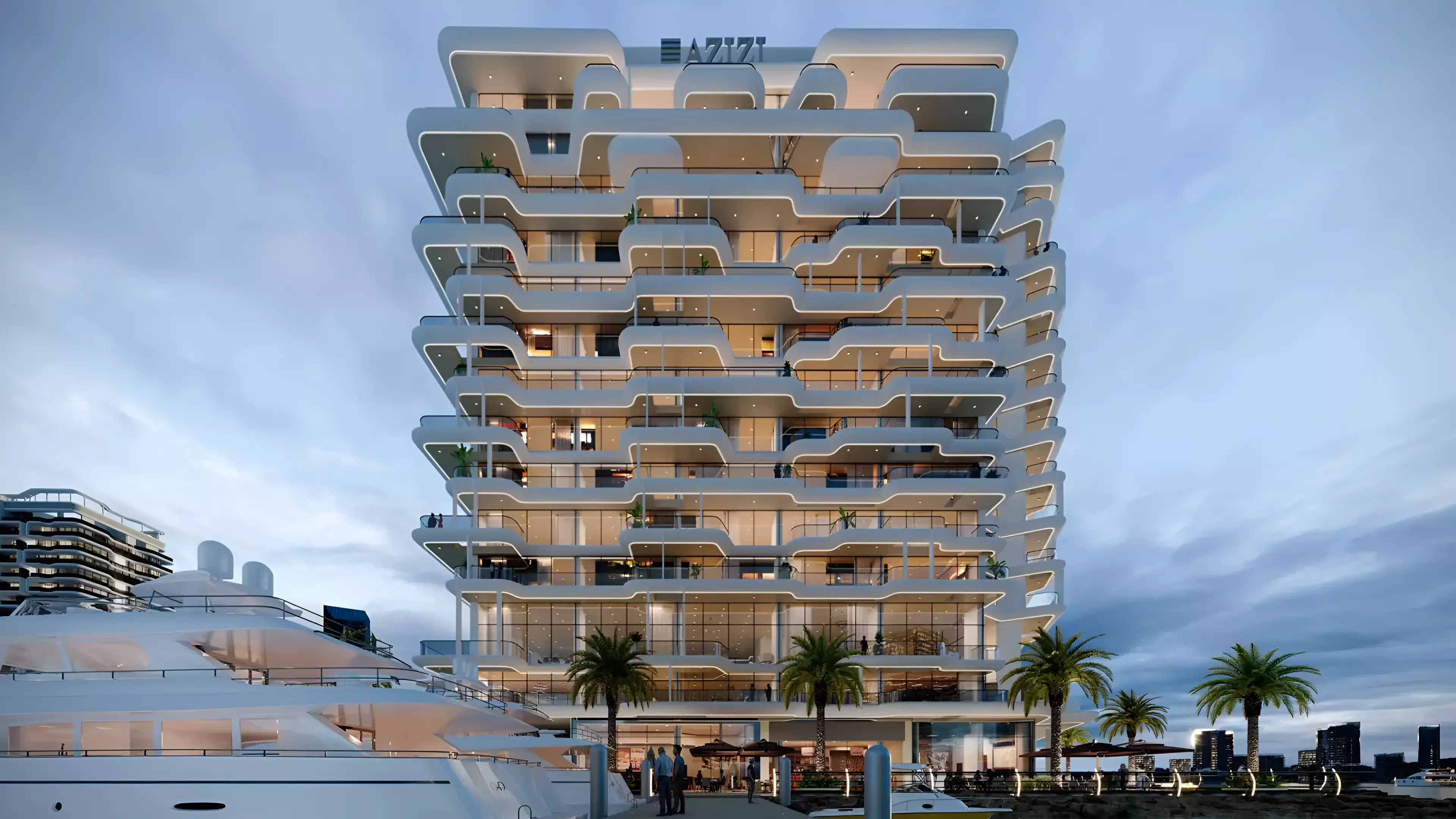 Front view of Azizi Wasel in Dubai with modern wave-like balconies and a luxury yacht docked at the marina during sunset.