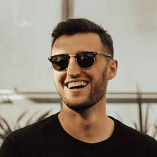 Smiling man wearing sunglasses outdoors