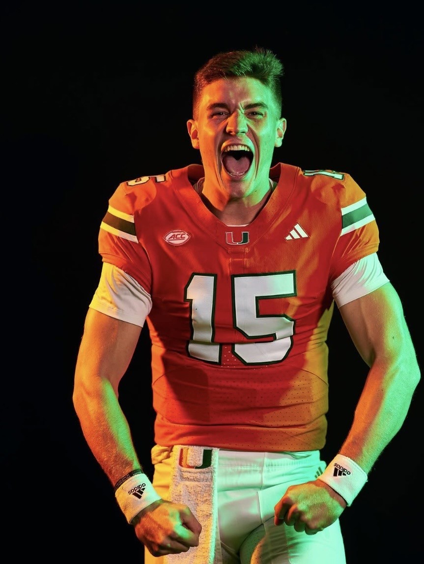 Judd Anderson in an orange jersey with the number 15 is shouting energetically, fists clenched, against a dark background with green and orange lighting.