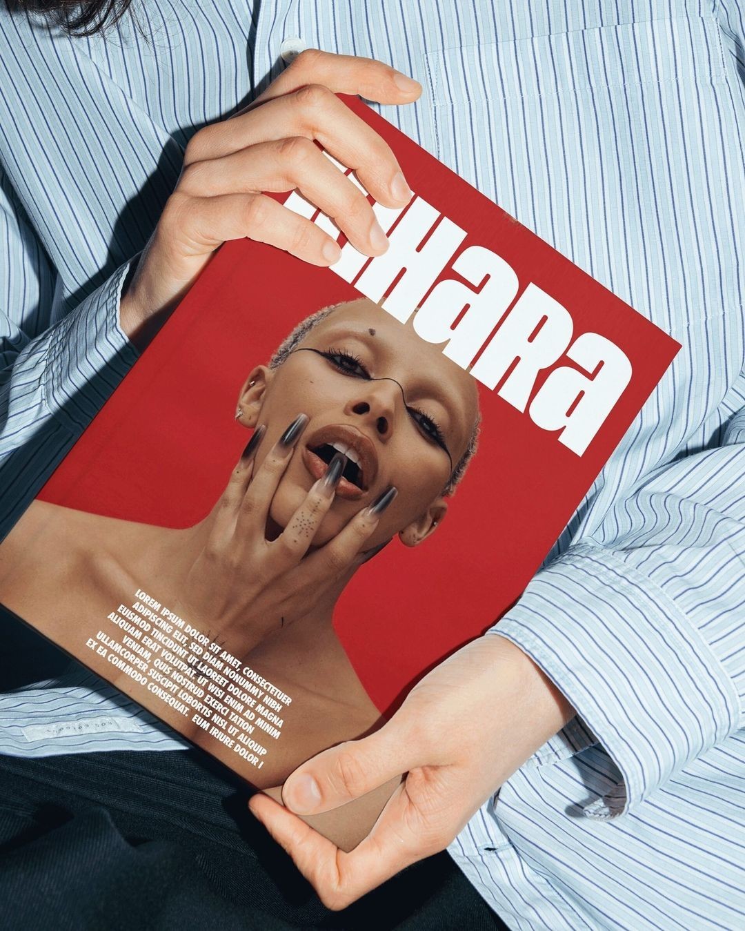 Hands holding fashion magazine cover