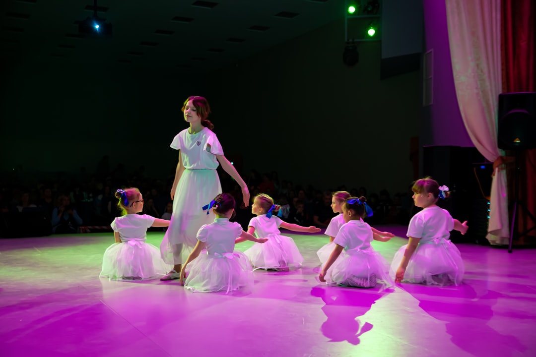 a group of girls in dresses and dresses on a stage