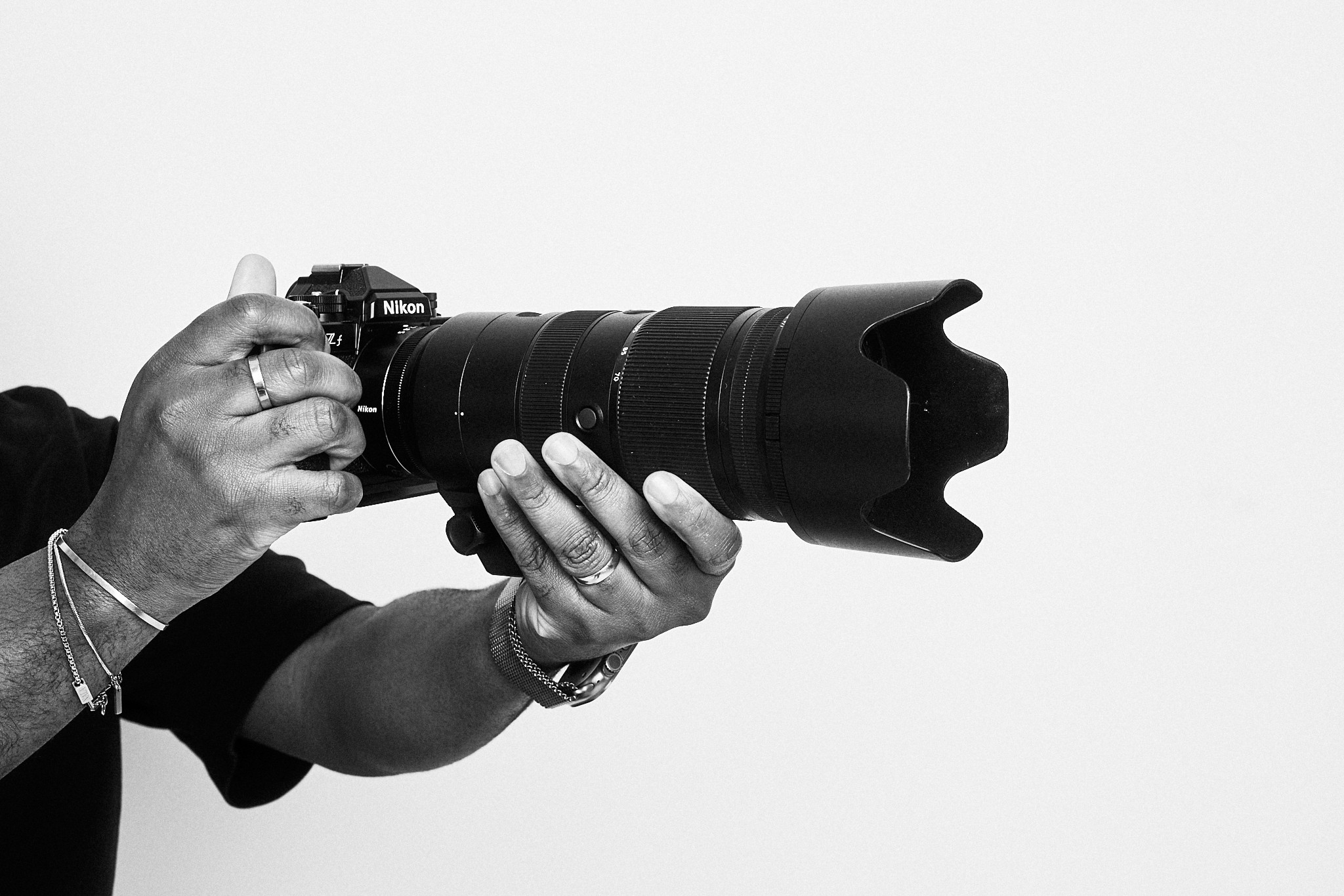 Three female friends sitting on a bench sipping coffee