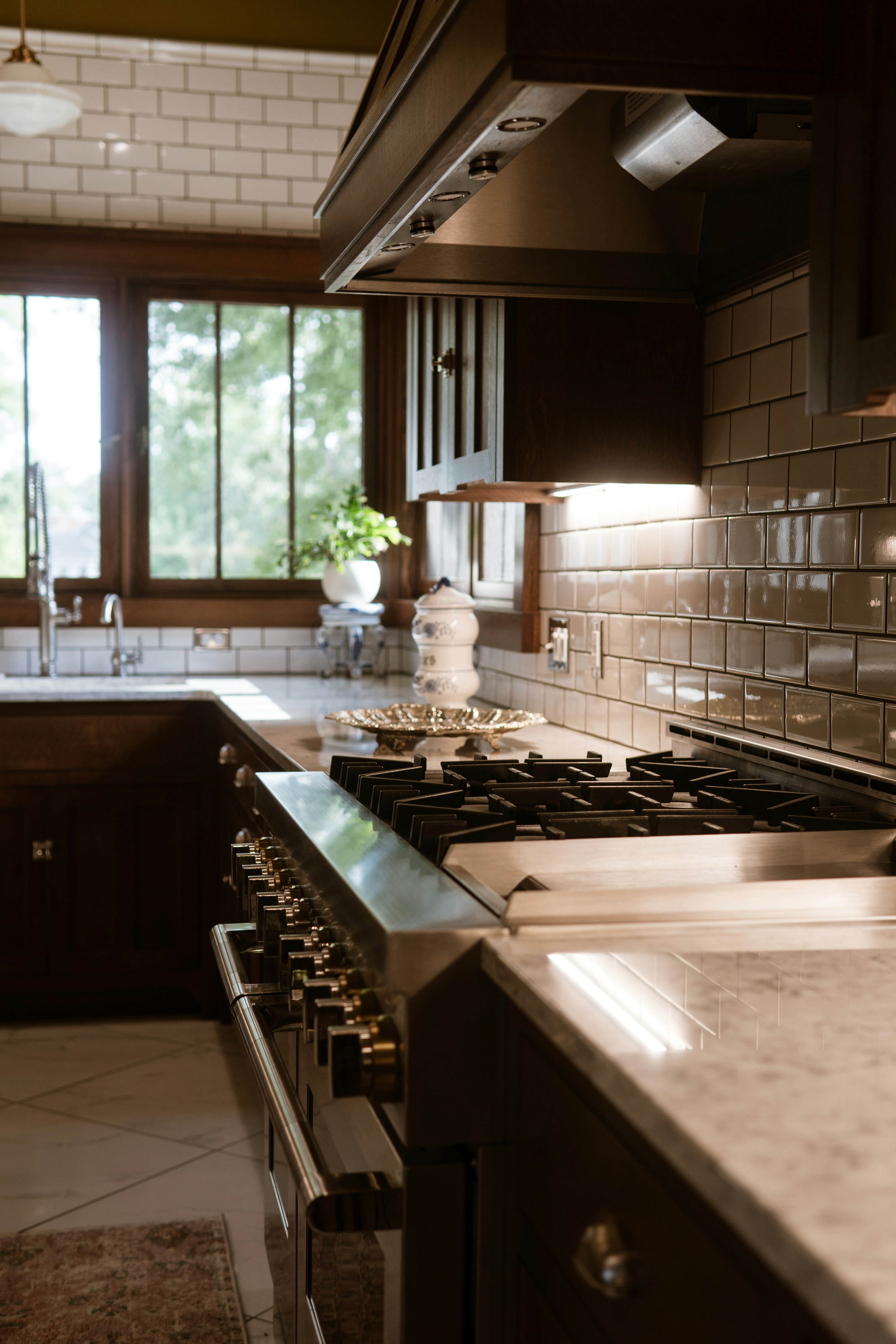 A kitchen with a stove top oven and a sink