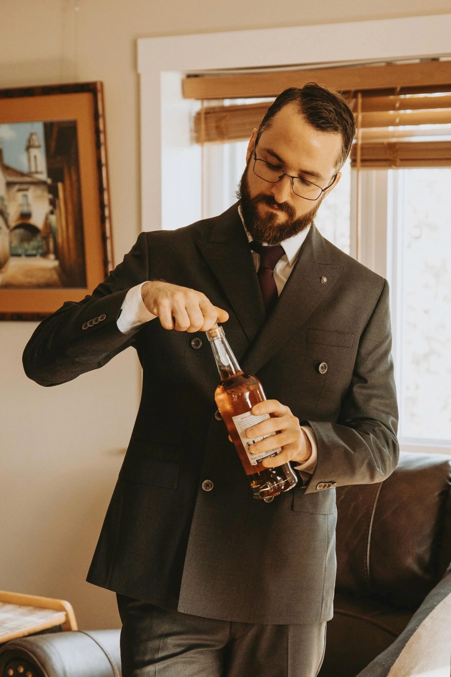 Two people embrace closely, wrapped in colorful, patterned blankets.