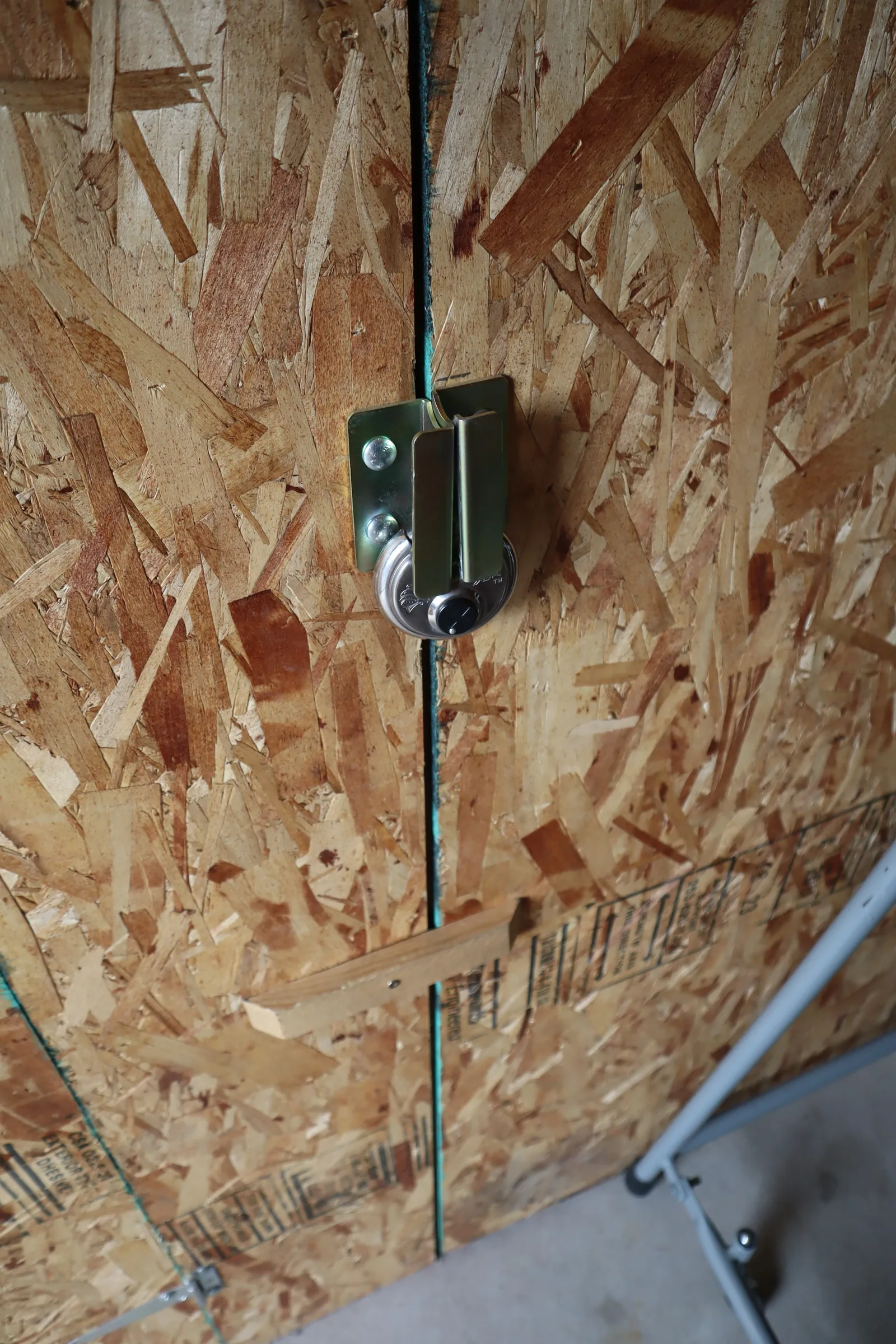 Storage locker door latch and padlock