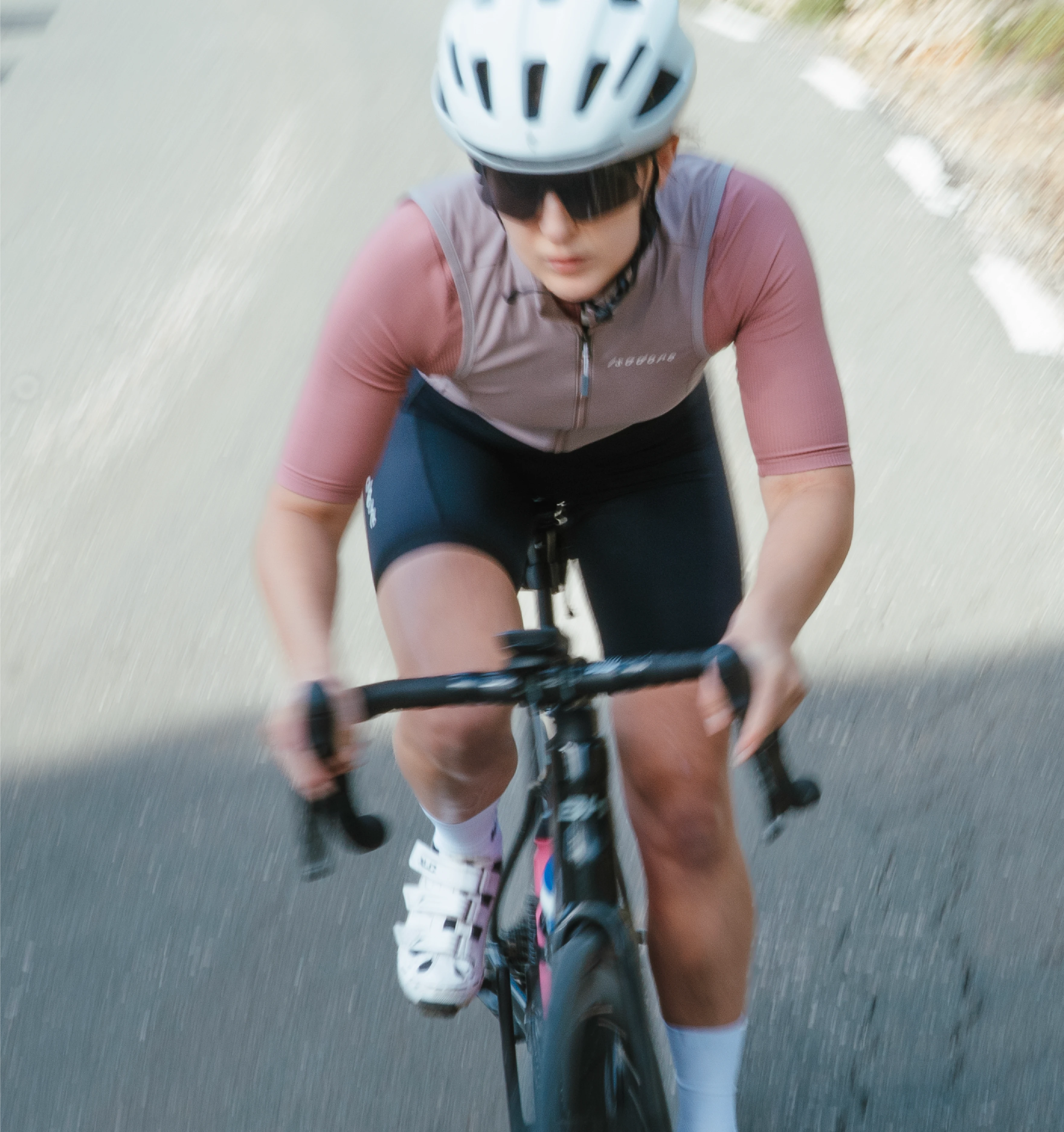 a woman cycling up the road.