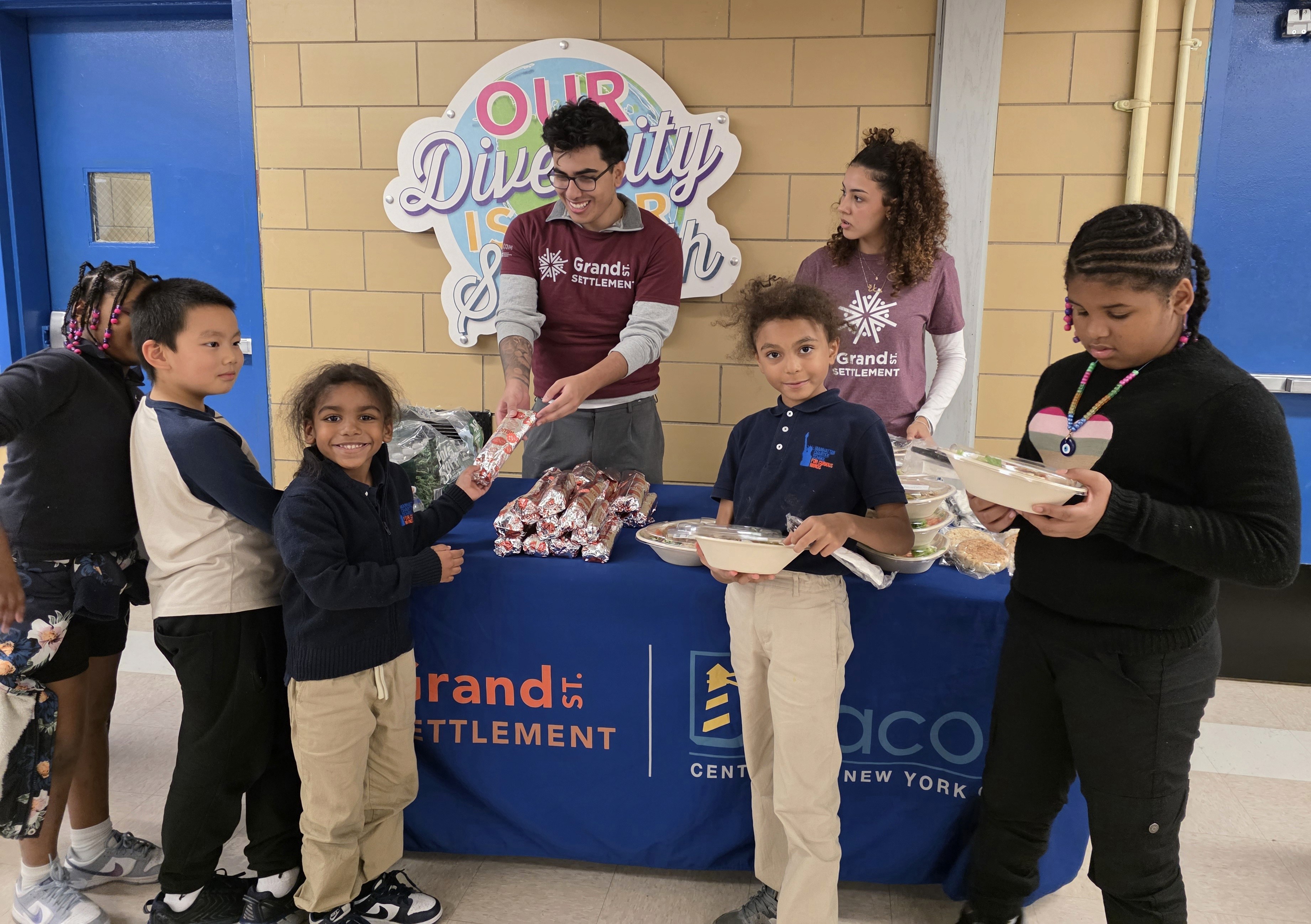 Children receive meals from volunteers.