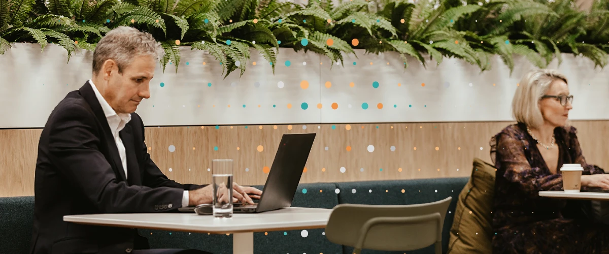 Lean Tree team member looking at laptop and working in a coworking space