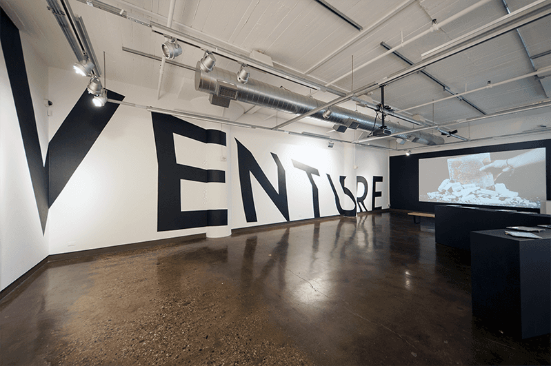venture vinyl word installed on the wall