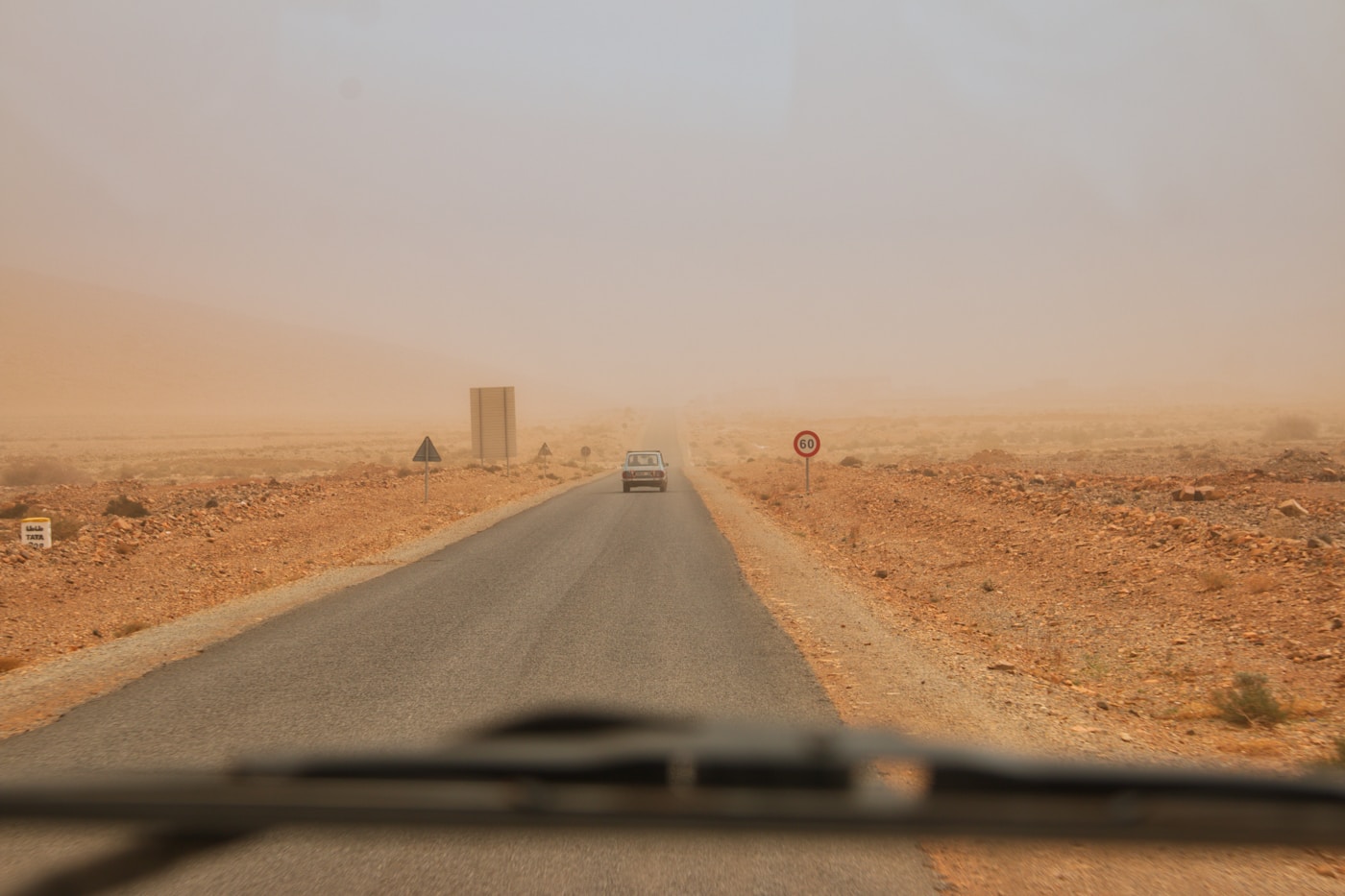 A 4x4 driving a gravel road through open Namibian country