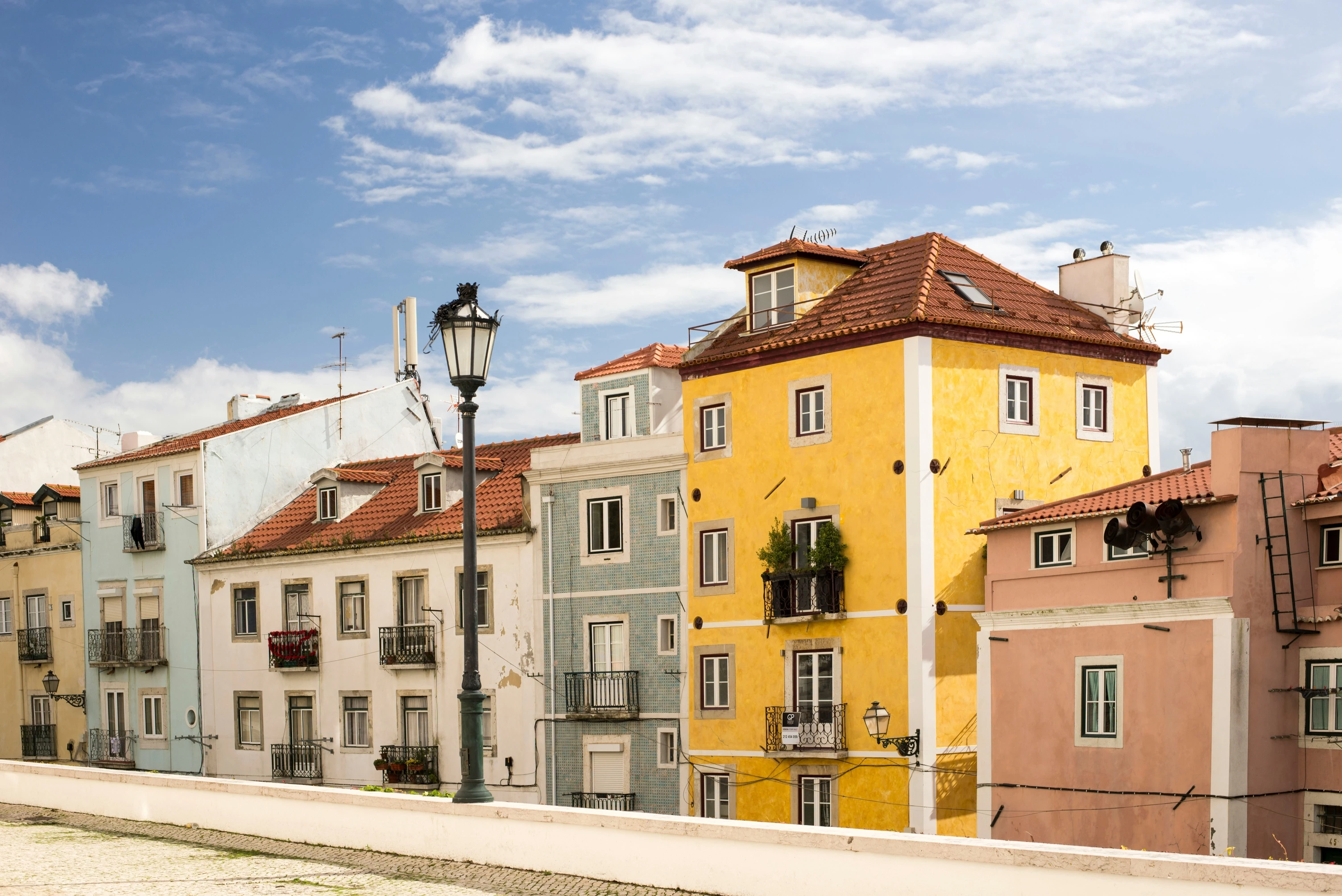 assorted-color building under cloudy blue sky during daytime