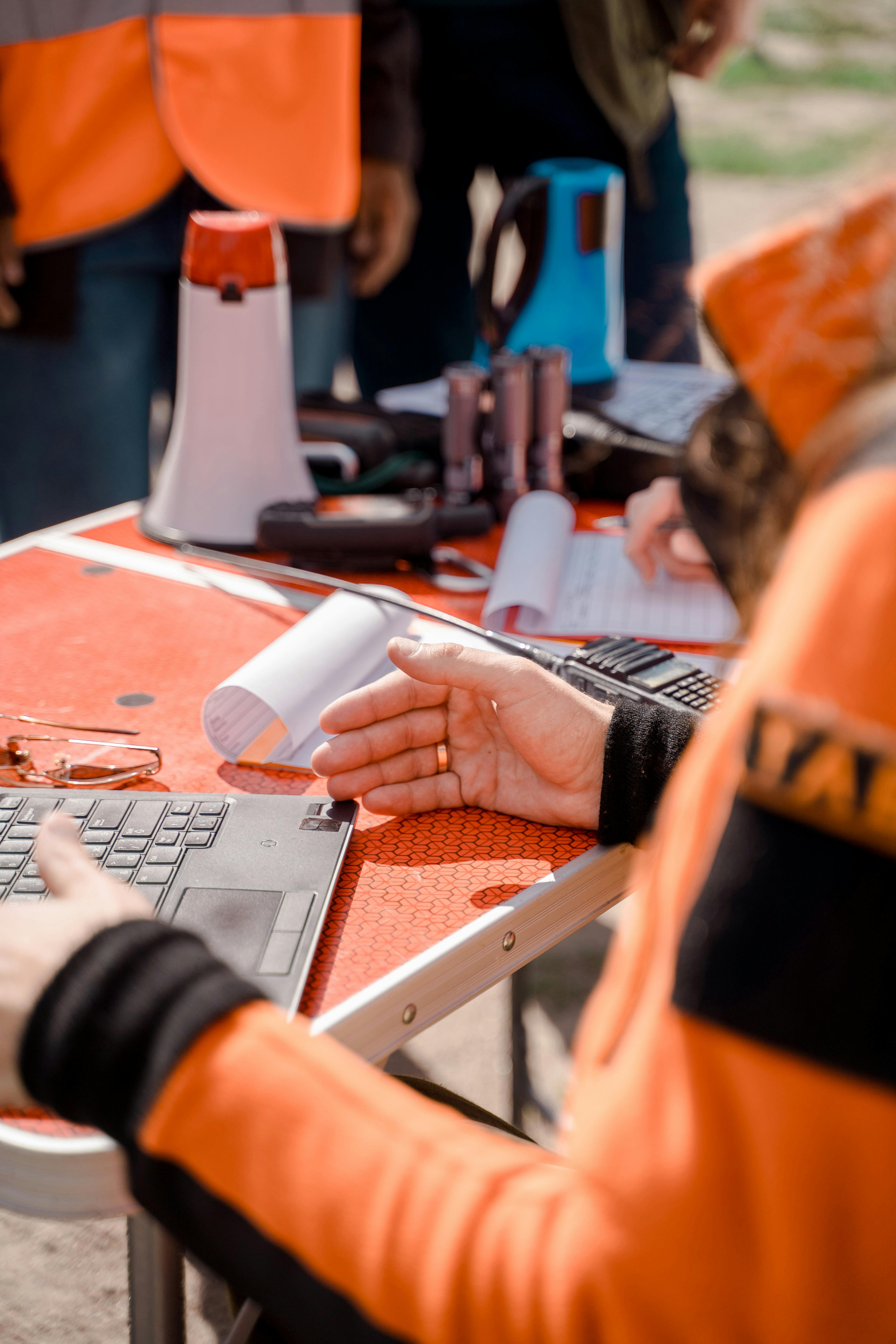 Close-up of a modern mechanical keyboard with a grey control knob and an orange accent key.