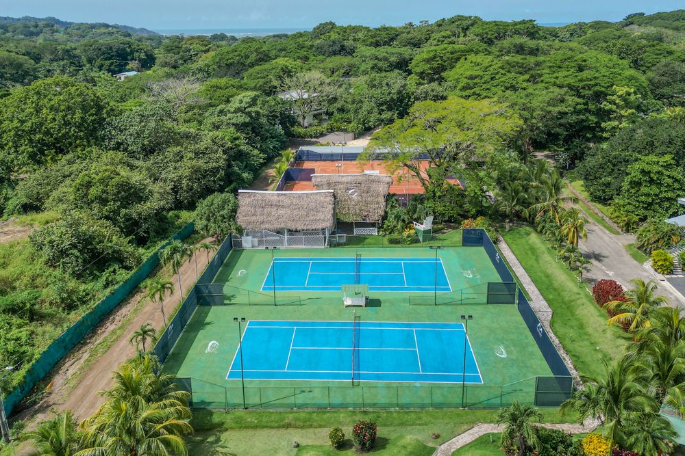 Tennis courts surrounded by jungle