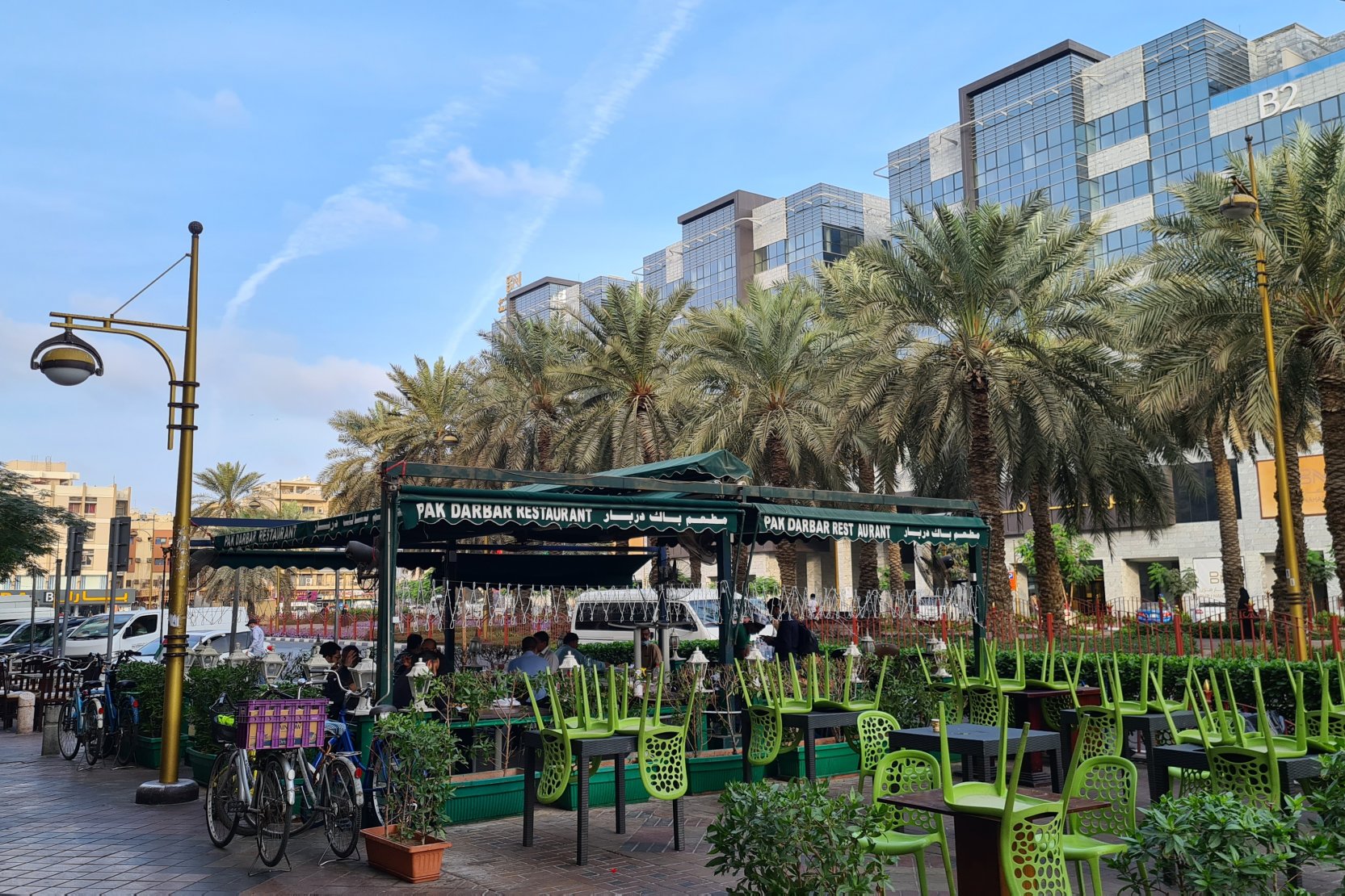 Outdoor dining at Pak Darbar, Muteena Dubai. Find residential properties near vibrant local services with our agents.