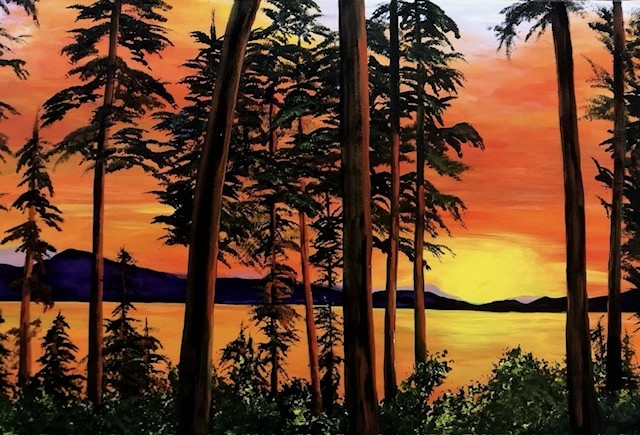 A vivid sunset paints the sea and sky orange, the glow reflecting of the trees in the foreground.