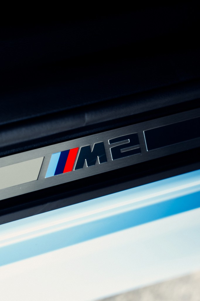 Close-up of BMW M2 logo in baby blue