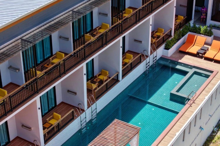 sunloungers fronting buildings near mountain