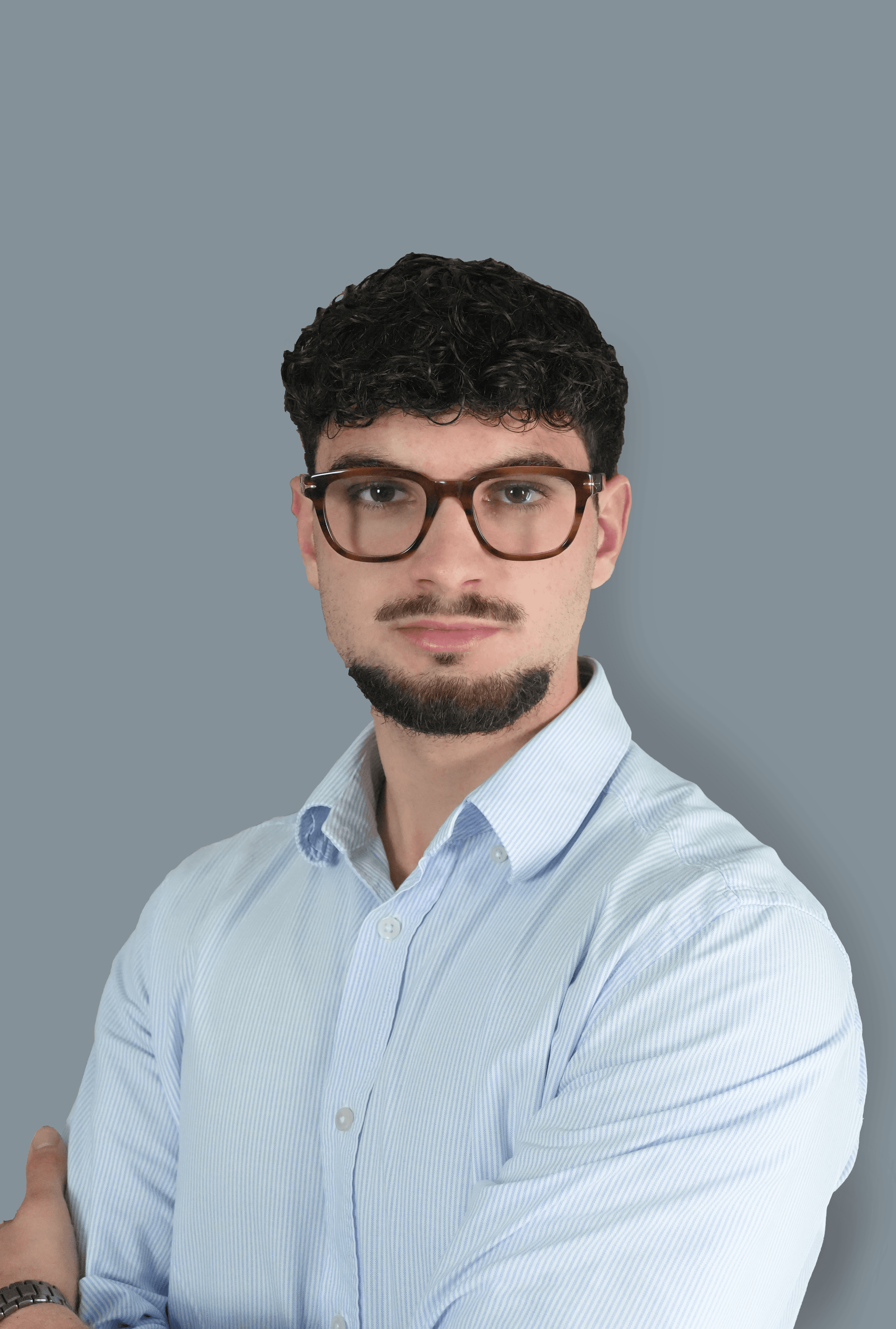 A modern house with large windows and a flat roof, surrounded by greenery against a clear blue sky.